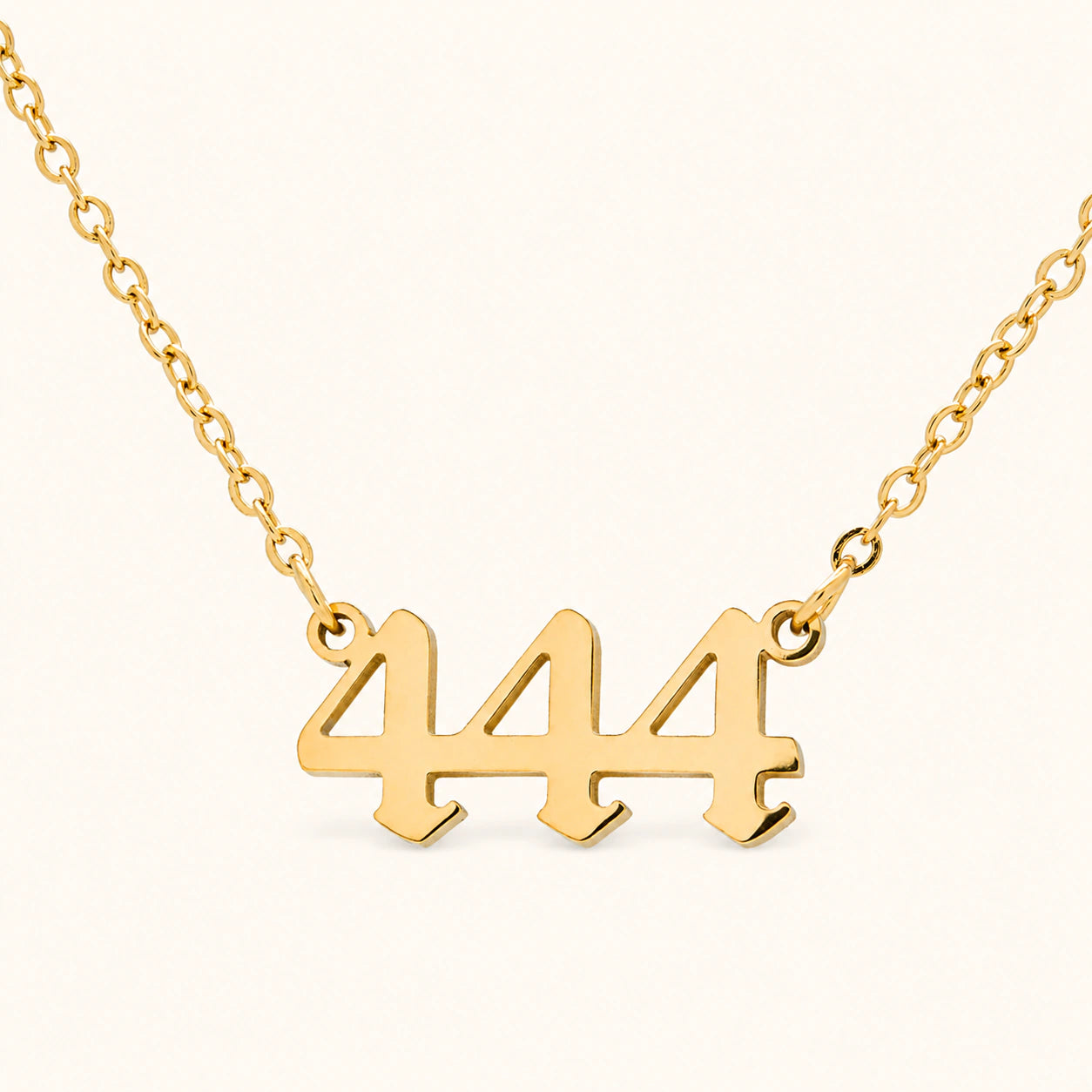 444 18k gold angel number necklace with bold numeral pendant on a gold necklace